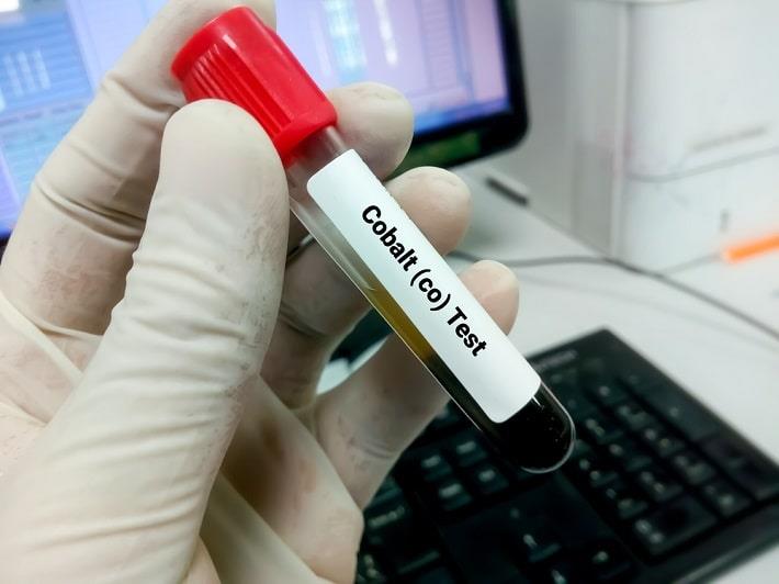 יד עם כפפה אוחזת במבחנה של בדיקת קובלט בדם